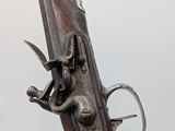 a close up of a gun that is on display on a table