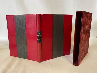 two red and black books sitting next to each other on a white surface
