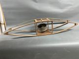 a small wooden boat with a bell on it
