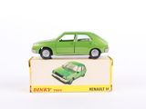 une petite voiture verte posée sur une boîte