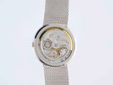 a close up of a watch on a white surface