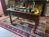 a desk with a laptop on top of it in a living room