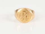 a gold signet ring with the letter n on it