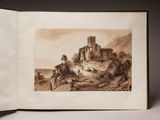 an open book with a drawing of a castle on top of a hill