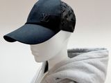 a mannequin head wearing a black hat and a gray hoodie