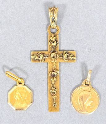 a close up of a cross with a medal and a coin