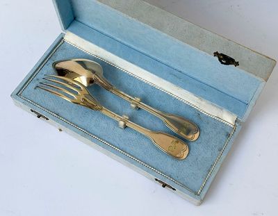 a silverware set in a blue box on a white surface