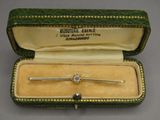 a close up of a tie bar in a case on a table