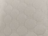 close up of a white pillow with a pattern on it