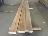 several pieces of wood are stacked on top of each other in a warehouse