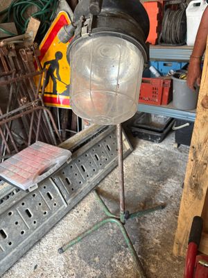 un homme debout à côté d'une lampe dans un garage