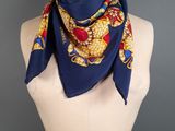 a woman wearing a blue and yellow scarf on a mannequin