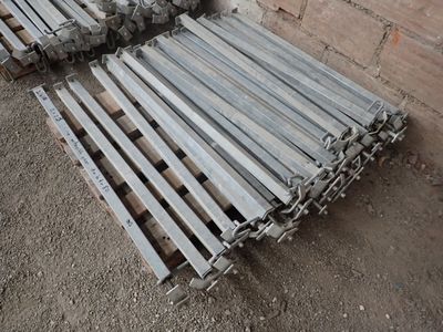 several pieces of wood are stacked on top of each other in front of a brick wall