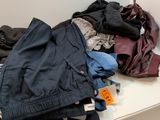 a pile of clothes sitting on a table in front of a mirror