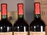 three bottles of wine sitting on a table next to a box