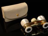 a pair of binoculars sitting on a table next to a wallet