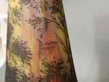 a vase that has a picture of a tree on it