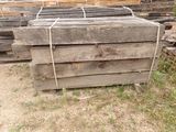 several pieces of wood are stacked on top of each other in a yard