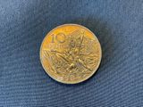 a close up of a coin on a blue cloth