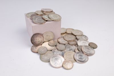 a small pink box filled with coins on a white surface