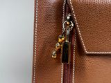 the back of a brown purse with a zipper on it