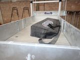 a bag sitting in the back of a truck bed