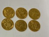 six gold sovereigns of various sizes and shapes