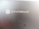 someone is holding a laptop with a chromebook logo on it
