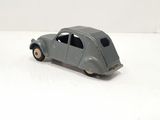 grey toy car on a white surface with a white background