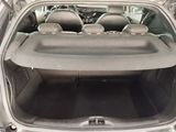 the back of a car with its trunk open and the seats folded down