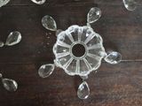 a glass object on a wooden table with a lot of pieces of glass scattered around it