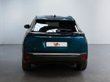 the rear end of a blue car in a room with a white wall