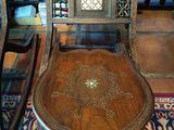 a wooden chair that is sitting on a rug