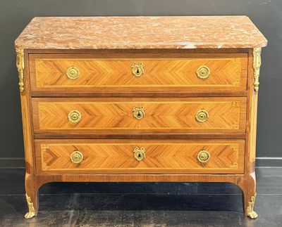 an antique chest of drawers with marble top