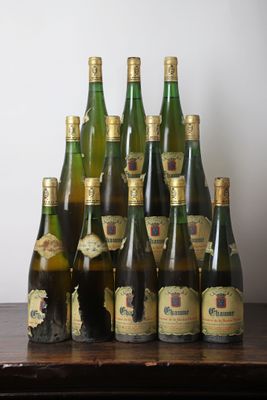 many bottles of wine sitting on a wooden table