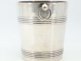 a silver cup with a ring on the handle