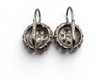 pair of antique silver earrings on a white background