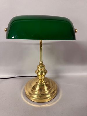brass desk lamp with green glass shade and brass base