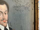 portrait of a man with a mustache in a gold frame