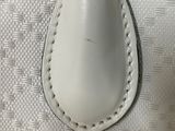 a close up of a pair of white shoes on a white surface