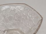 a glass bowl with a design on it on a white surface