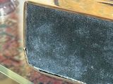 a silver purse sitting on top of a glass table