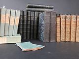 several old books are stacked on top of each other on a table