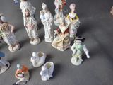 many figurines of people that are sitting on a table