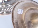 a silver plate with a sticker on it sitting on a table