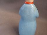 a small blue bottle with a white cap on it
