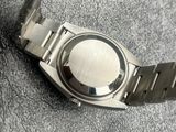 a close up of a watch on a metal bracelet