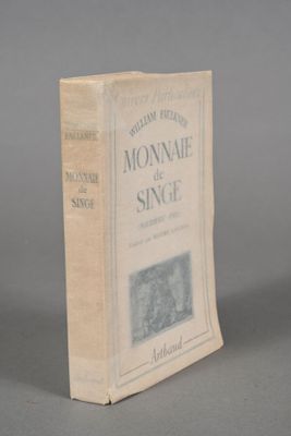 an old book sitting on top of a table on a gray surface