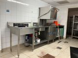 a kitchen with a sink, stove, and other items in it