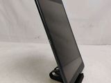 the tablet is sitting on a stand on a white surface